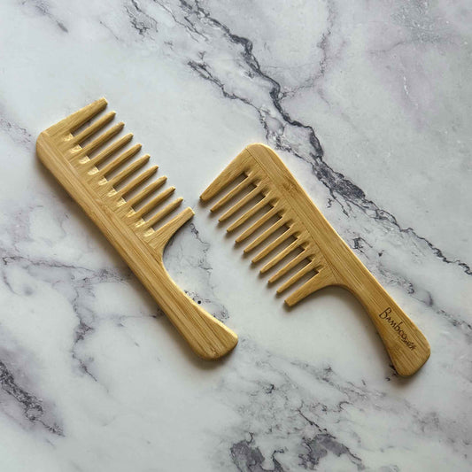 Two Bamboo Detangling Wide Combs on a marble surface