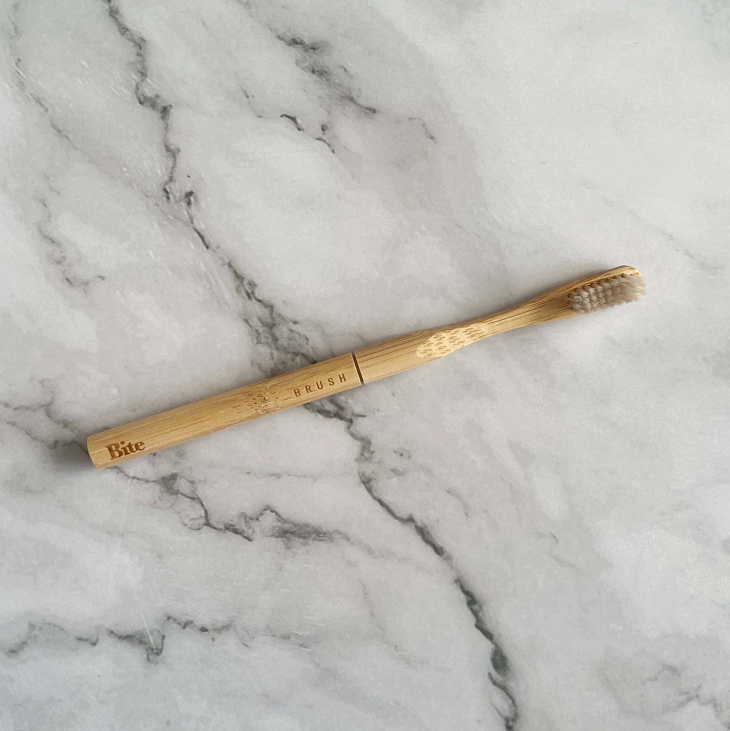 Bamboo toothbrush on a marble surface