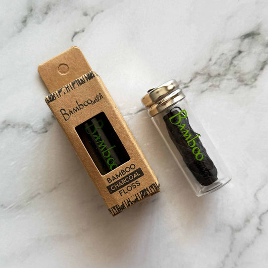 Bamboo charcoal floss packaging on a marble surface