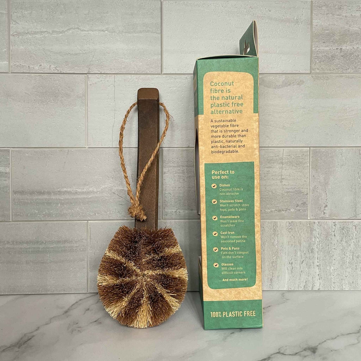 Coconut fiber scrubber with packaging on a tiled floor