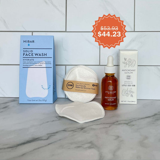 Face Care Bundle including Hydrate Face Wash Bar, Makeup Remover Pads, Antioxidant Serum on a tiled background