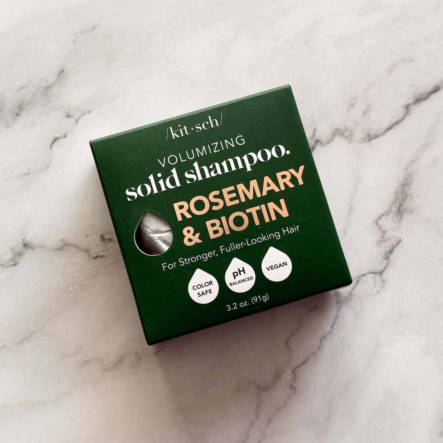 Kitsch volumizing solid shampoo box with rosemary and biotin on a marble background