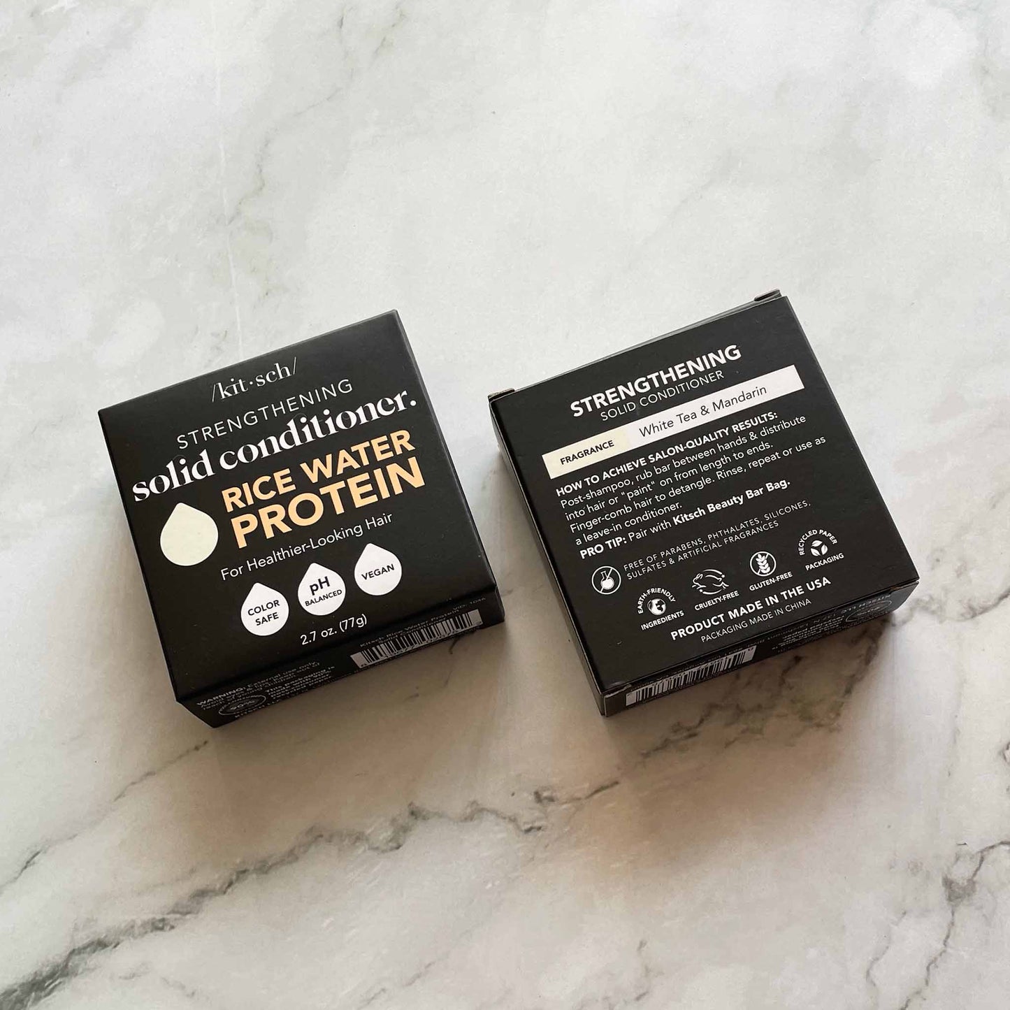 Two boxes of Kit-sch strengthening solid conditioner on a marble surface