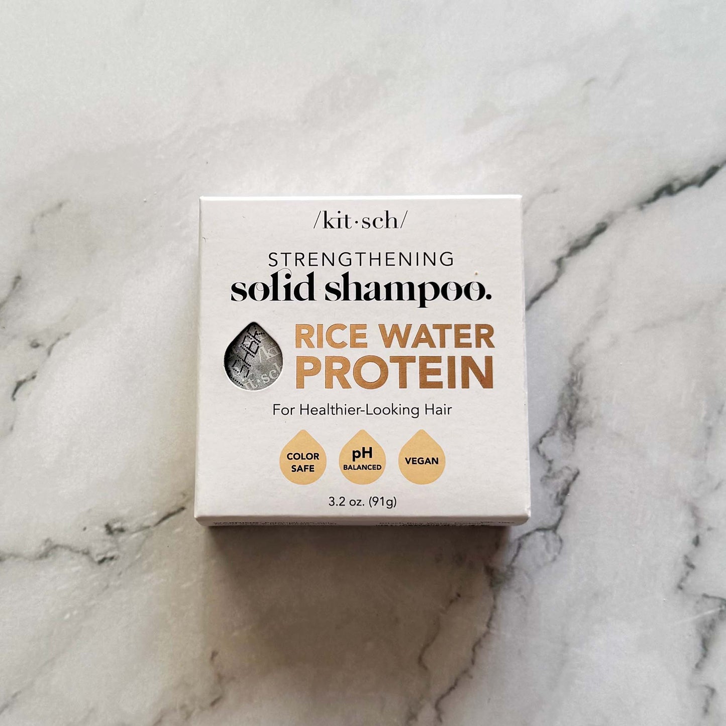 Kitsch Strengthening Solid Shampoo box on a marble surface