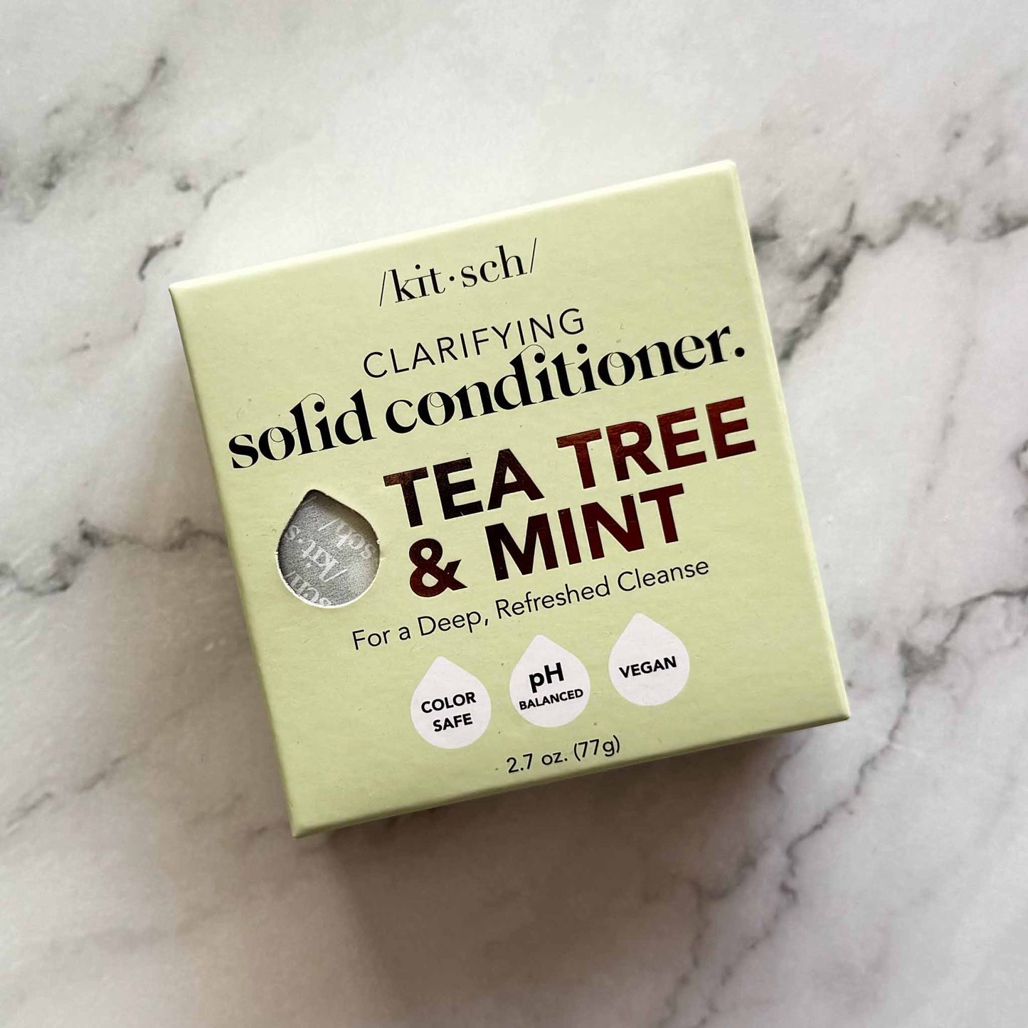 Box of Kitsch tea tree and mint clarifying solid conditioner on a marble surface