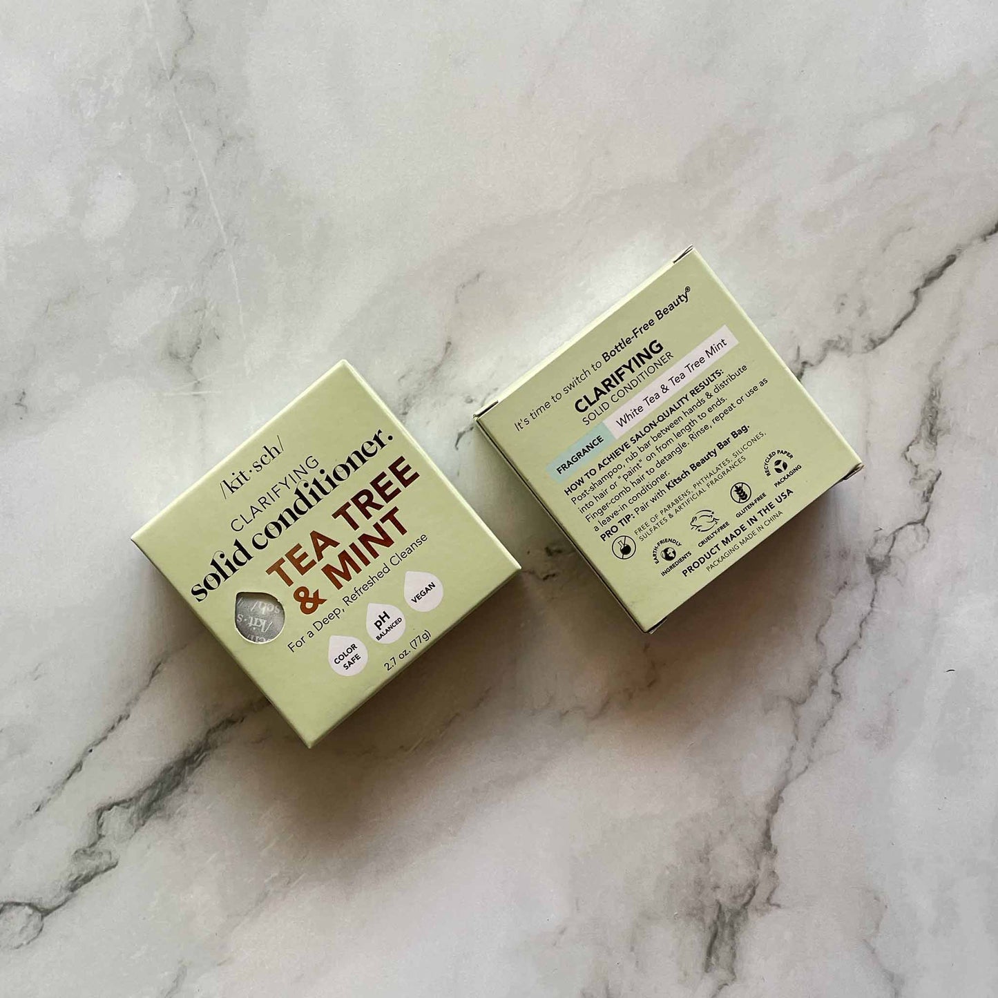 Two boxes of Kitsch Tea Tree & Mint solid conditioner on a marble surface