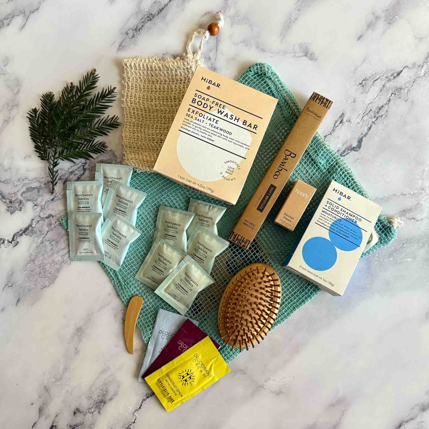 Collection of skin, oral and hair care products on a marble surface
