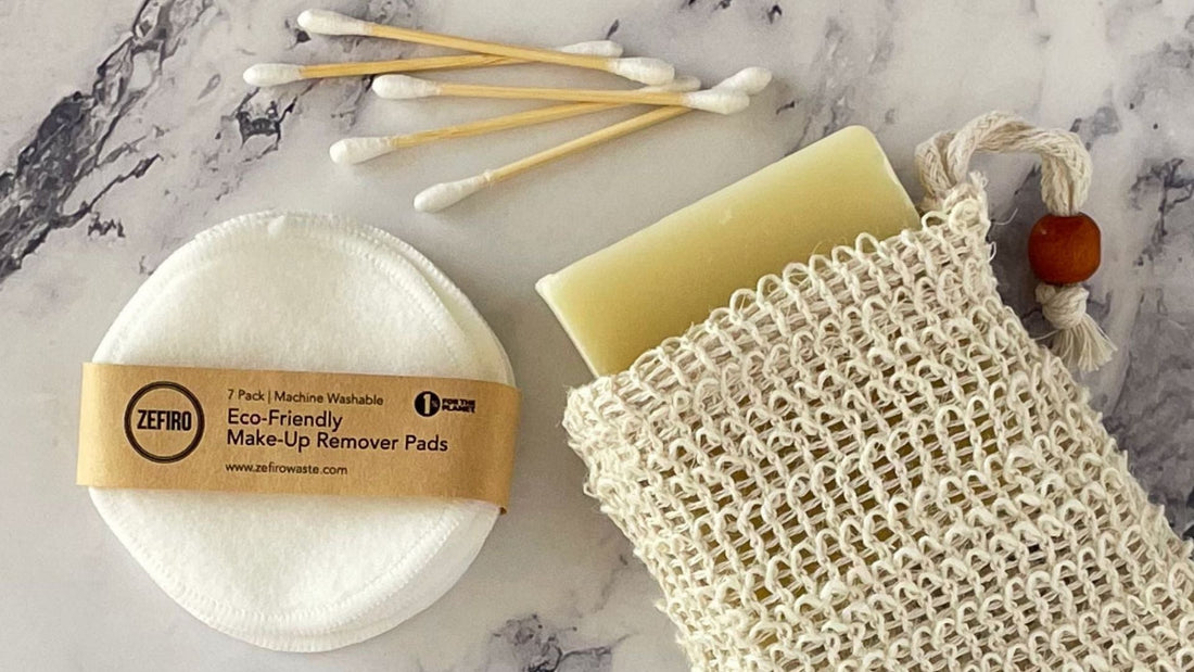 Eco-friendly make-up remover pads, sisal bag with soap bar in it, bamboo cotton swabs on a marble surface