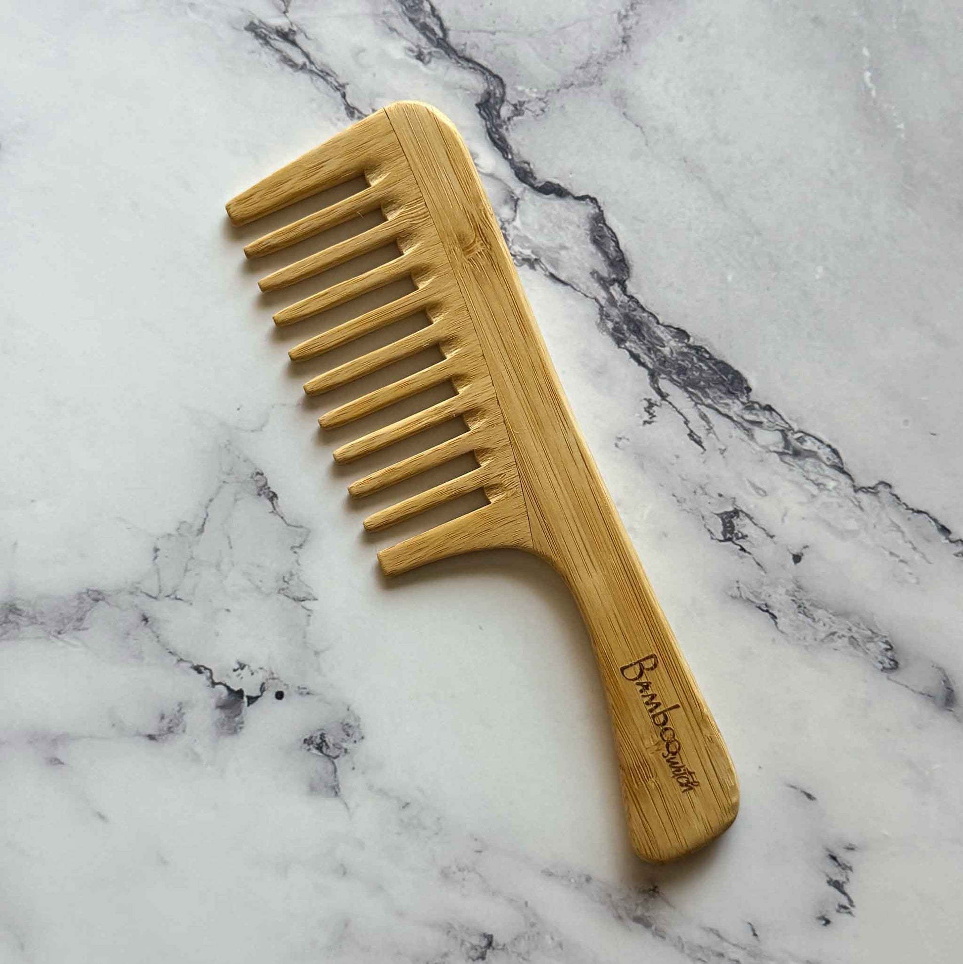 Bamboo Detangling Wide Comb on a marble surface