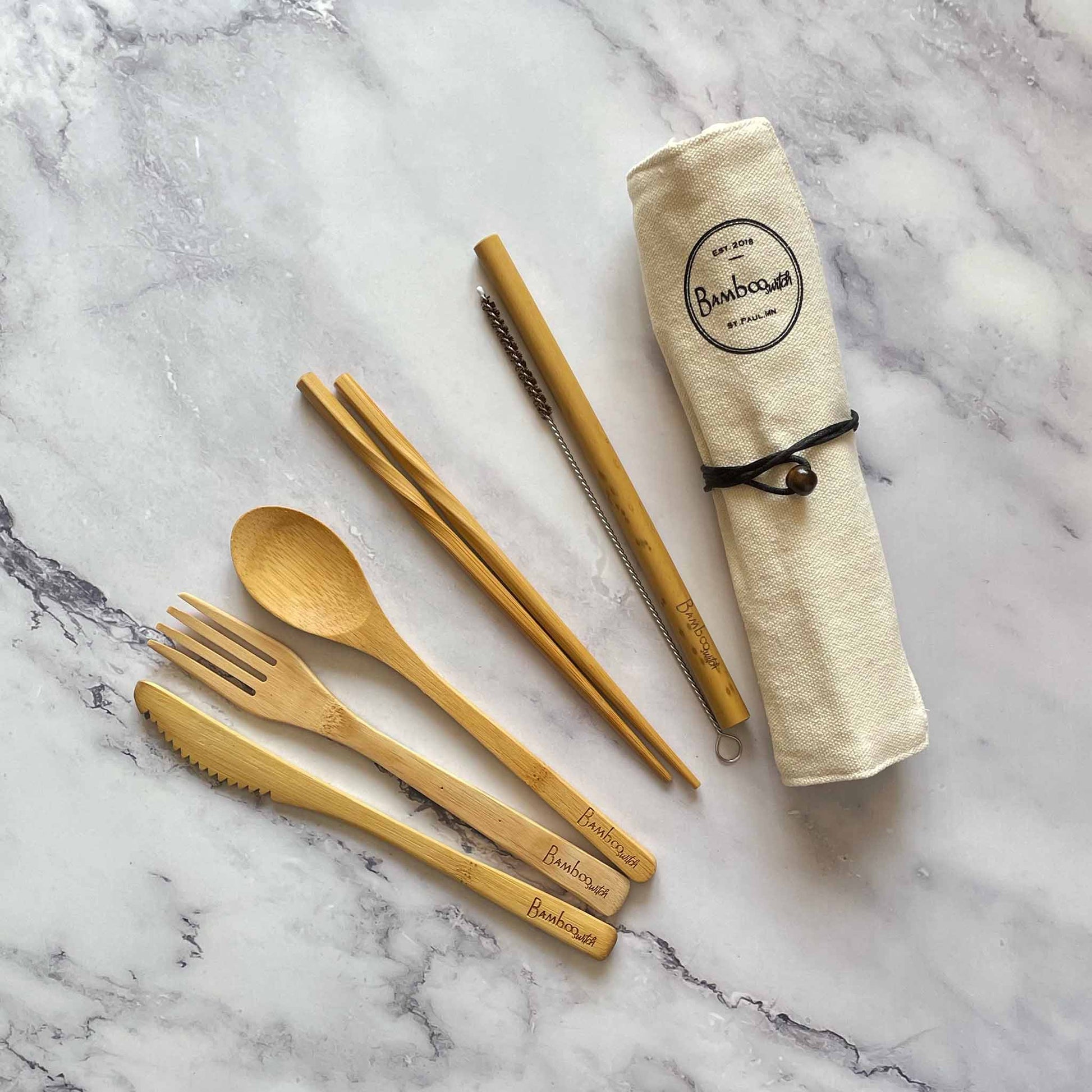 Bamboo Travel Cutlery Set including fork, spoon, knife, straw, straw cleaner, and chopsticks, in a cotton pouch