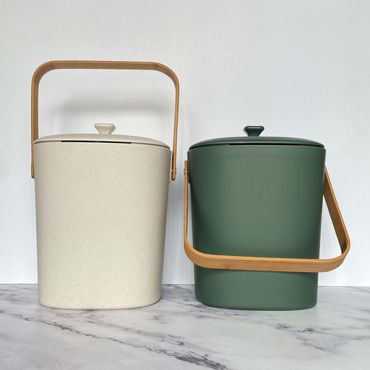 Bamboozle Compost Bins in Natural and Forest on a marble countertop