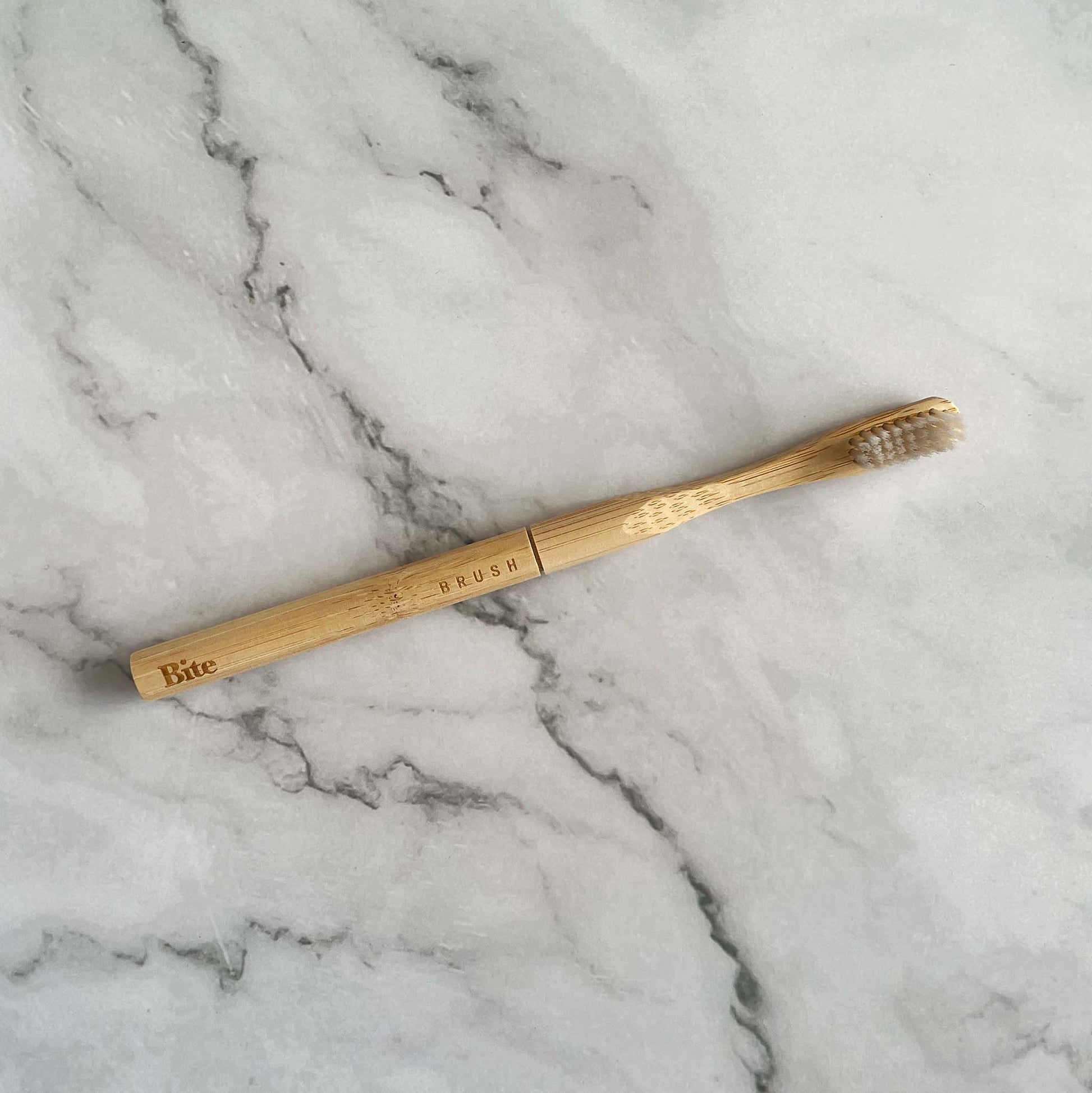 Bamboo toothbrush on a marble surface
