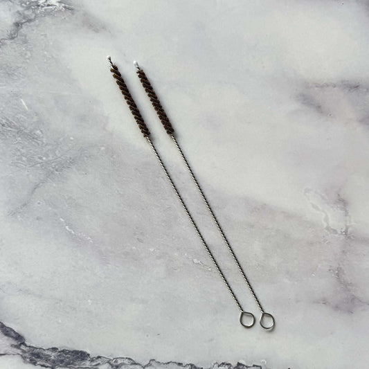 two coconut Fiber Straw Brushes on marble surface