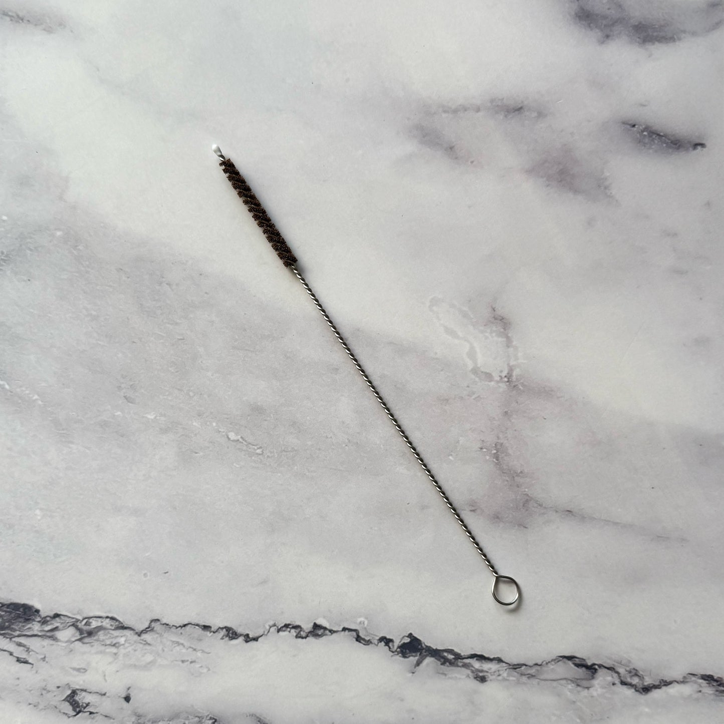 Coconut Fiber Straw Brush on marble surface