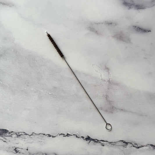 Coconut Fiber Straw Brush on marble surface