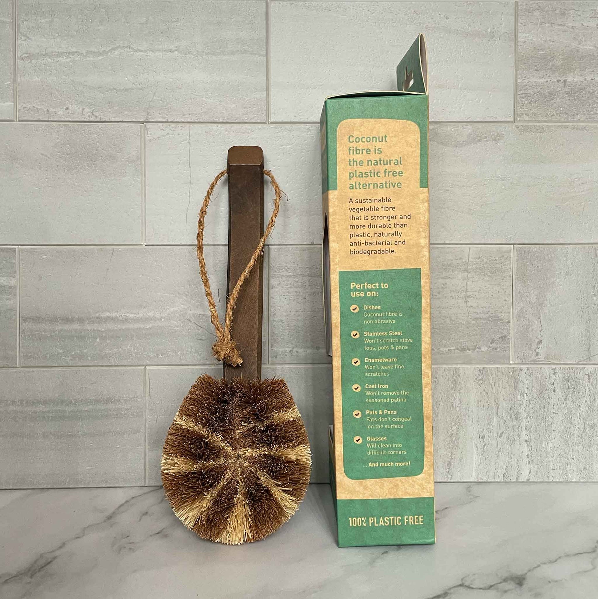 Coconut fiber scrubber with packaging on a tiled floor