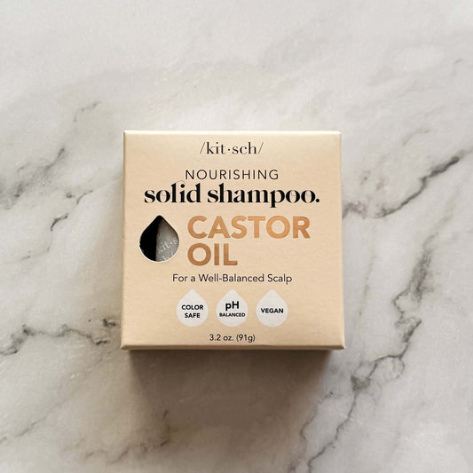 Box of 'kit-sch' nourishing solid shampoo with castor oil on a marble surface