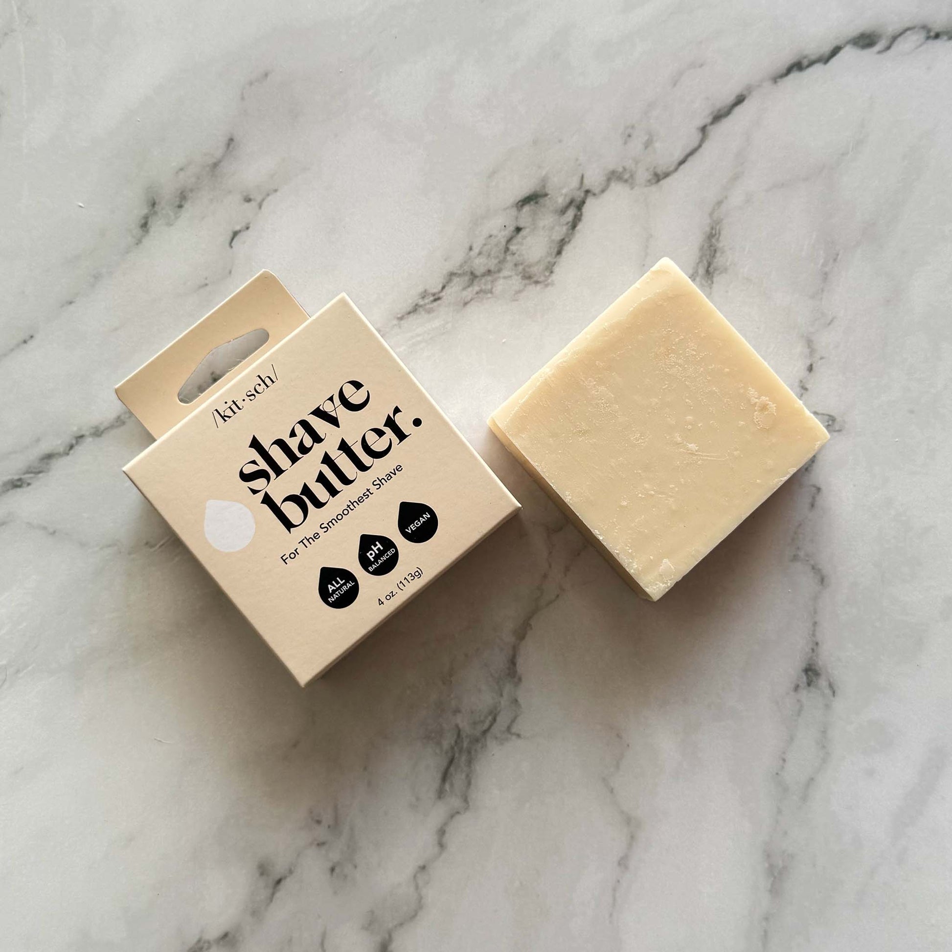 Kitsch Shave butter bar packaging and a bar on a marble surface