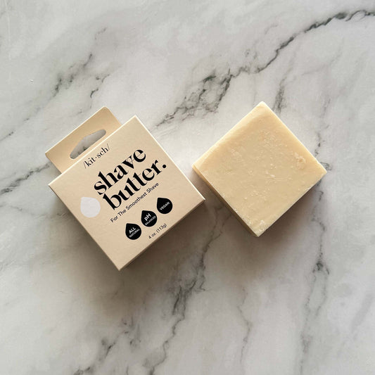 Kitsch Shave butter bar packaging and a bar on a marble surface
