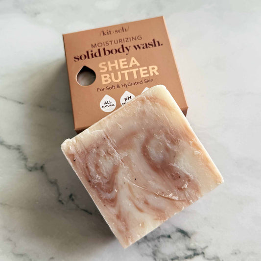 Kitsch Shea butter solid body wash bar with packaging on a marble surface