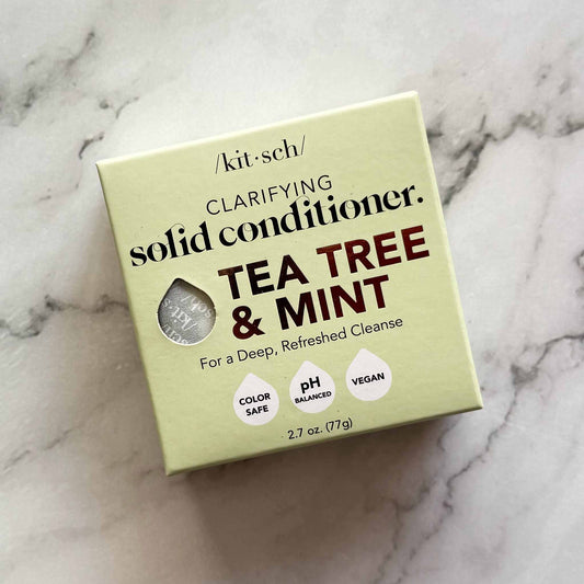 Box of Kitsch tea tree and mint clarifying solid conditioner on a marble surface