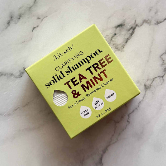 Box of Kitsch clarifying solid shampoo with tea tree and mint on a marble background