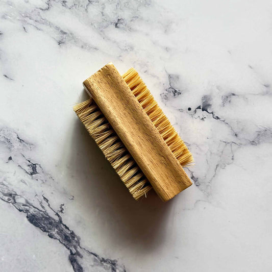 Wooden brush with bristles on a marble surface