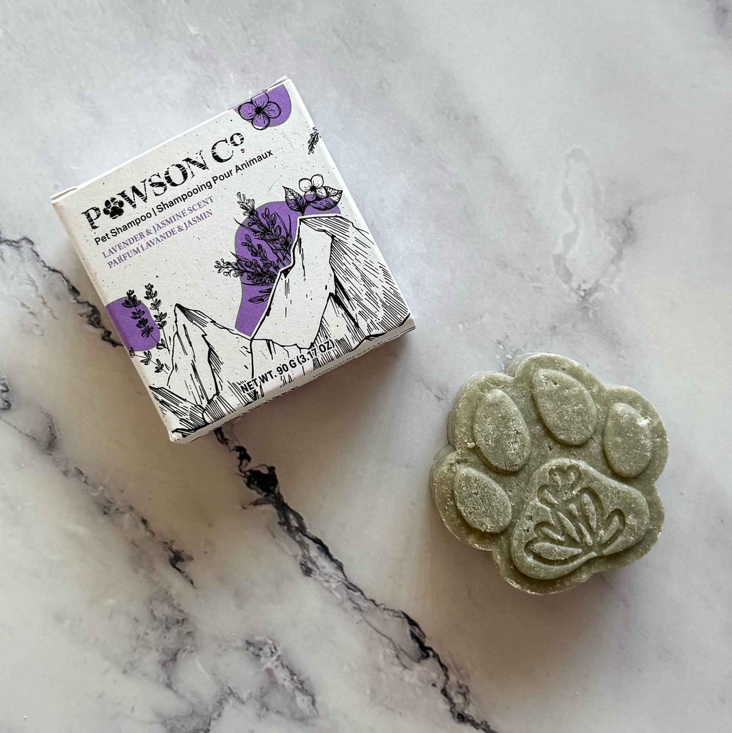 Pet Shampoo Bar in Lavender and Jasmine scent on a marble surface next to its box