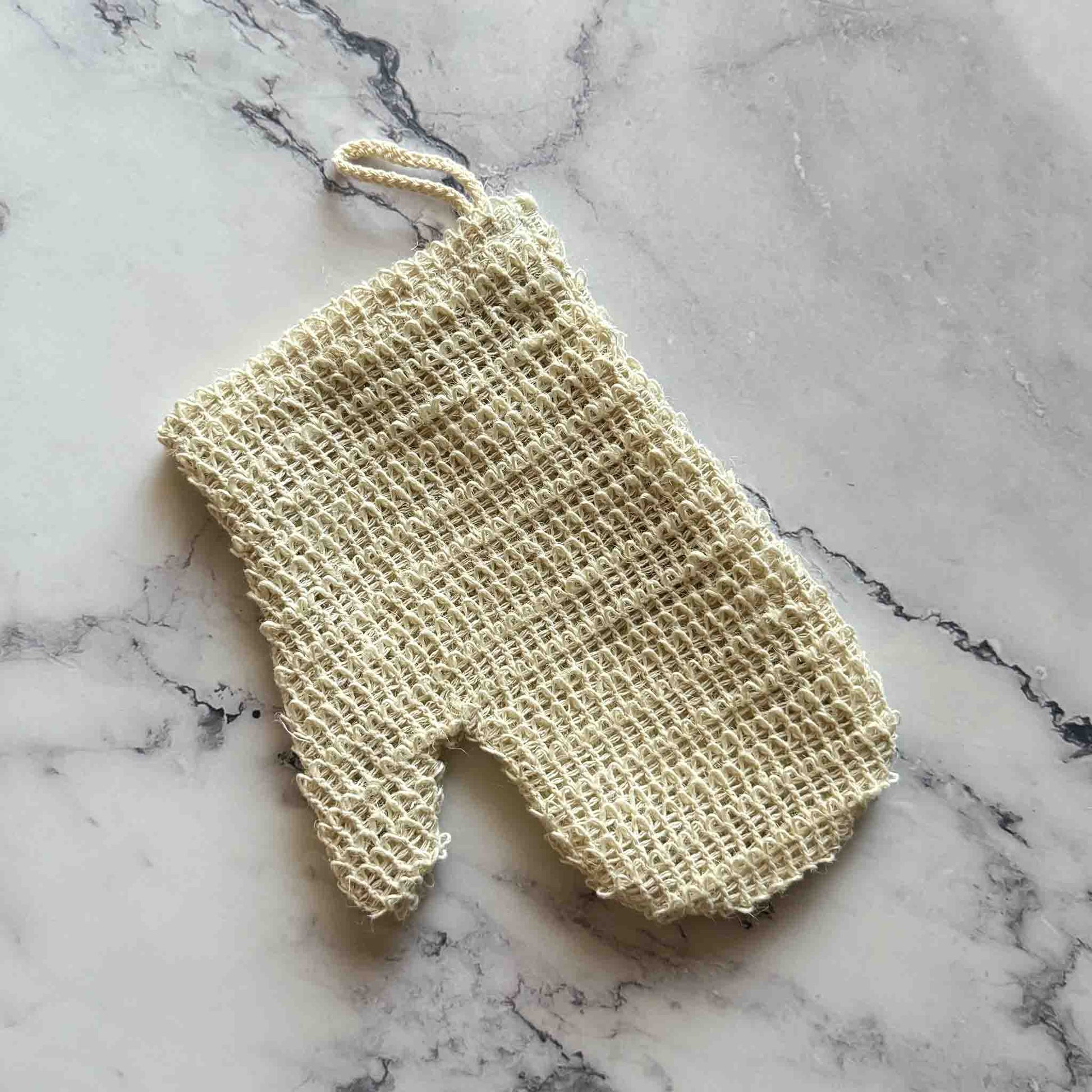 Sisal Exfoliating Shower Glove on marble surface
