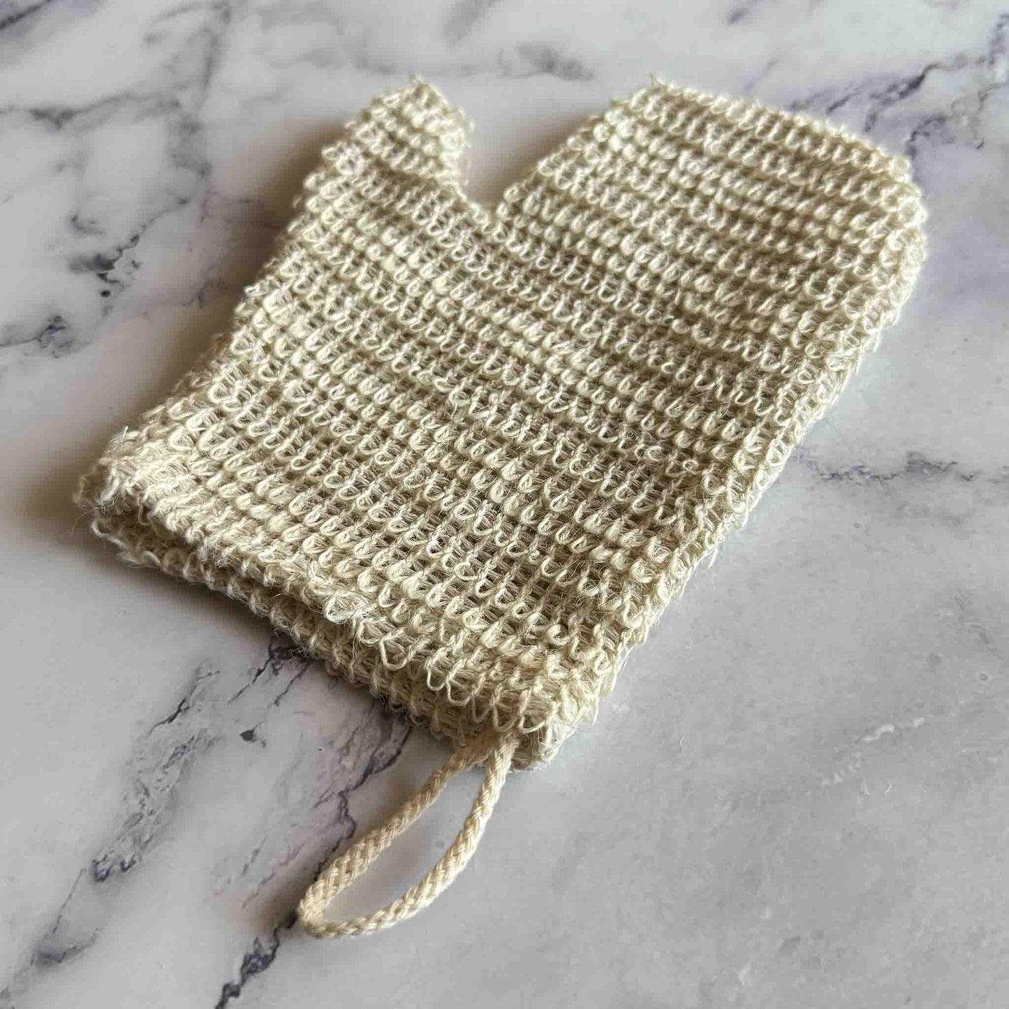 Sisal Exfoliating Shower Glove on marble surface
