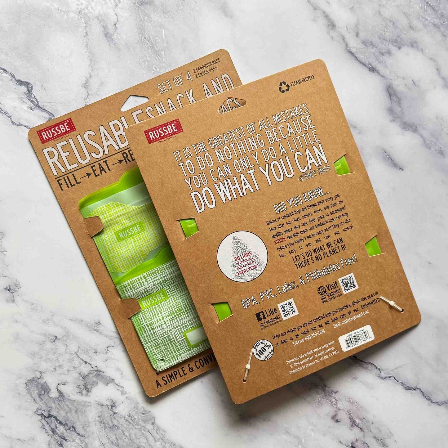 Russbe reusable snack and sandwich bags on a marble surface.