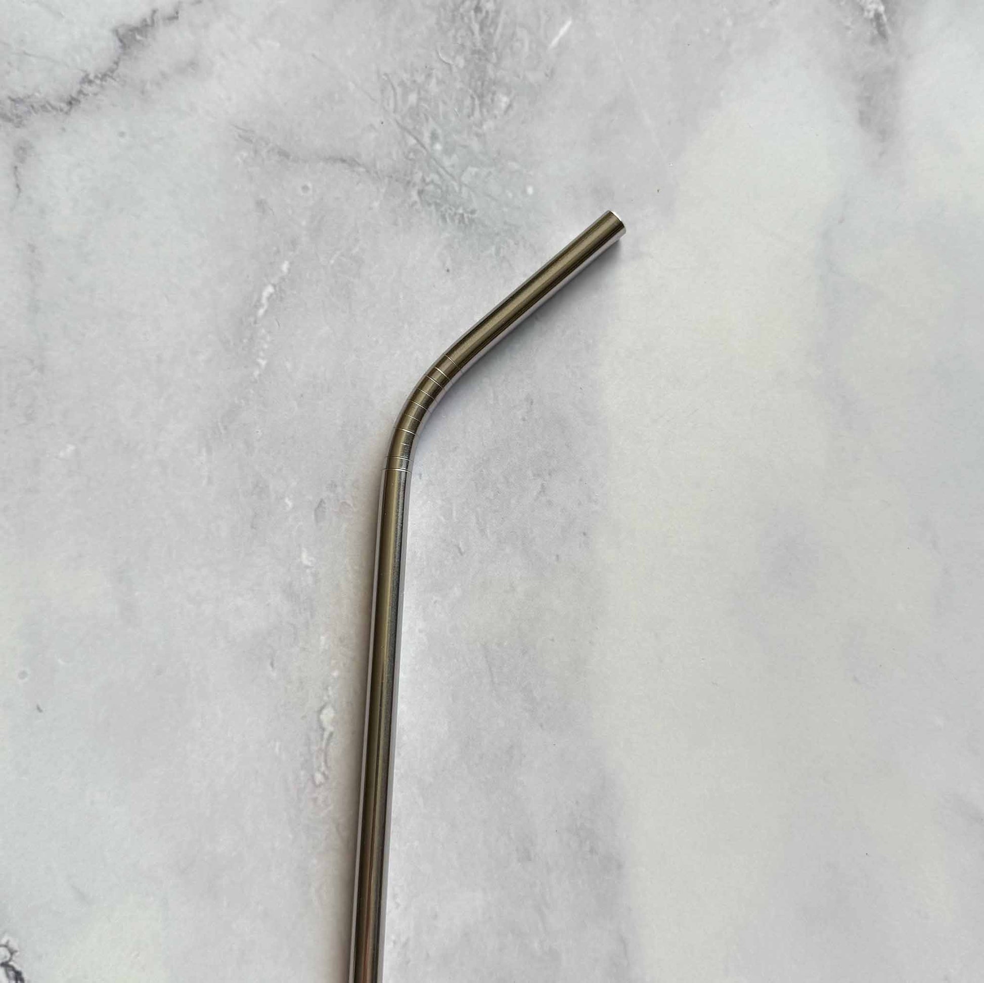 Stainless Steel bent straw on a marble surface