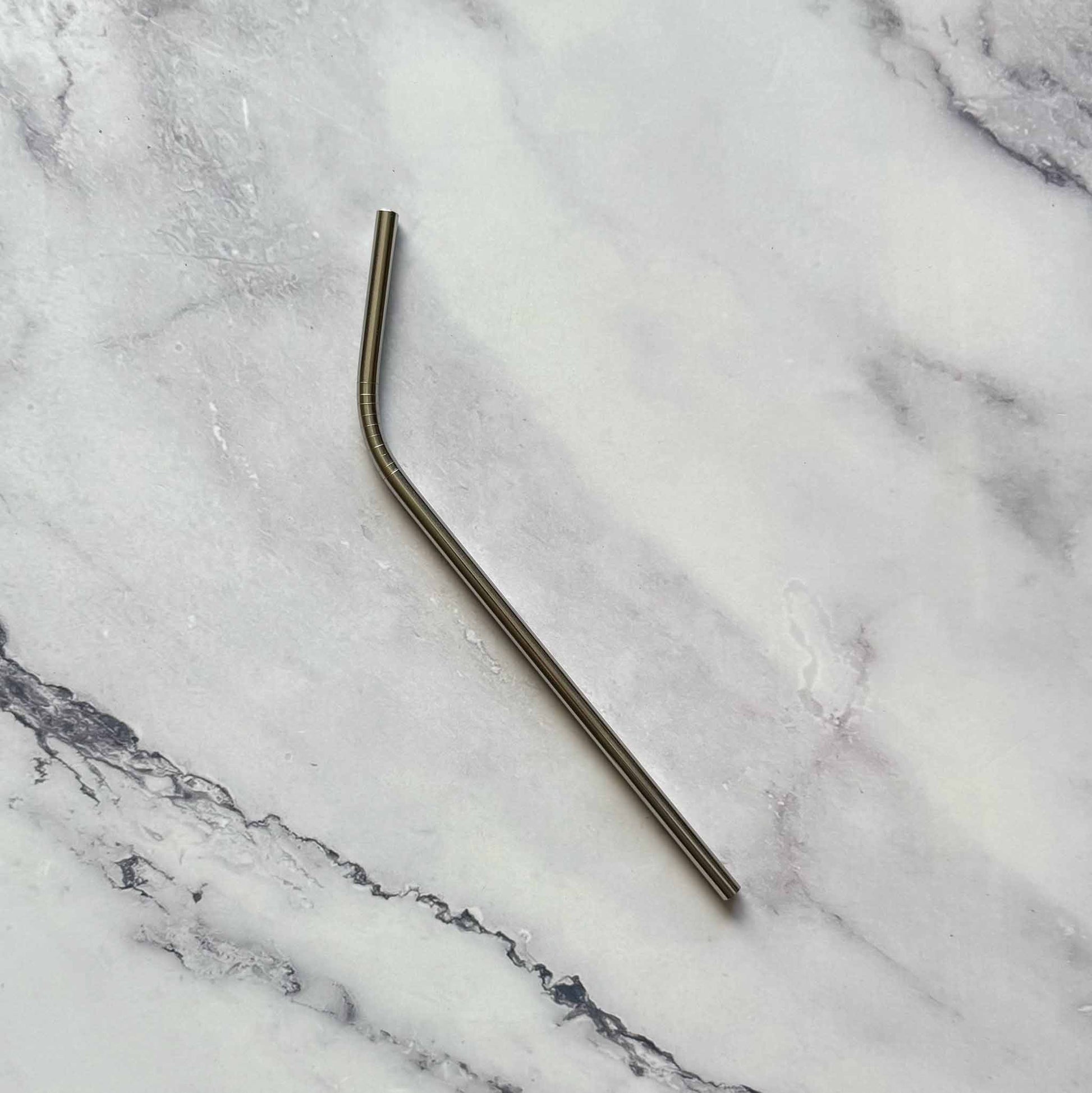 Stainless Steel bent straw on a marble surface