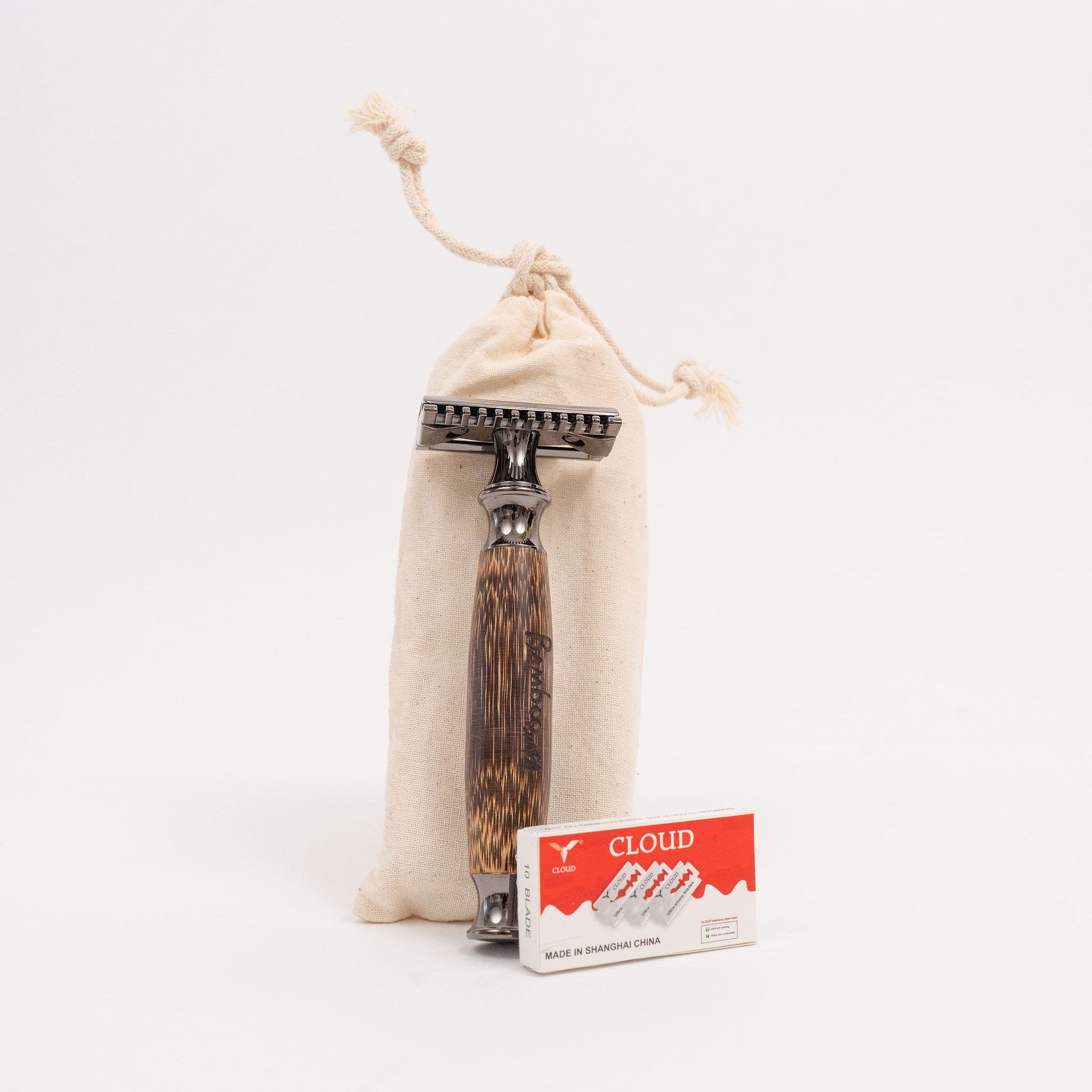 Stainless steel razor with curved handle, bag and blades