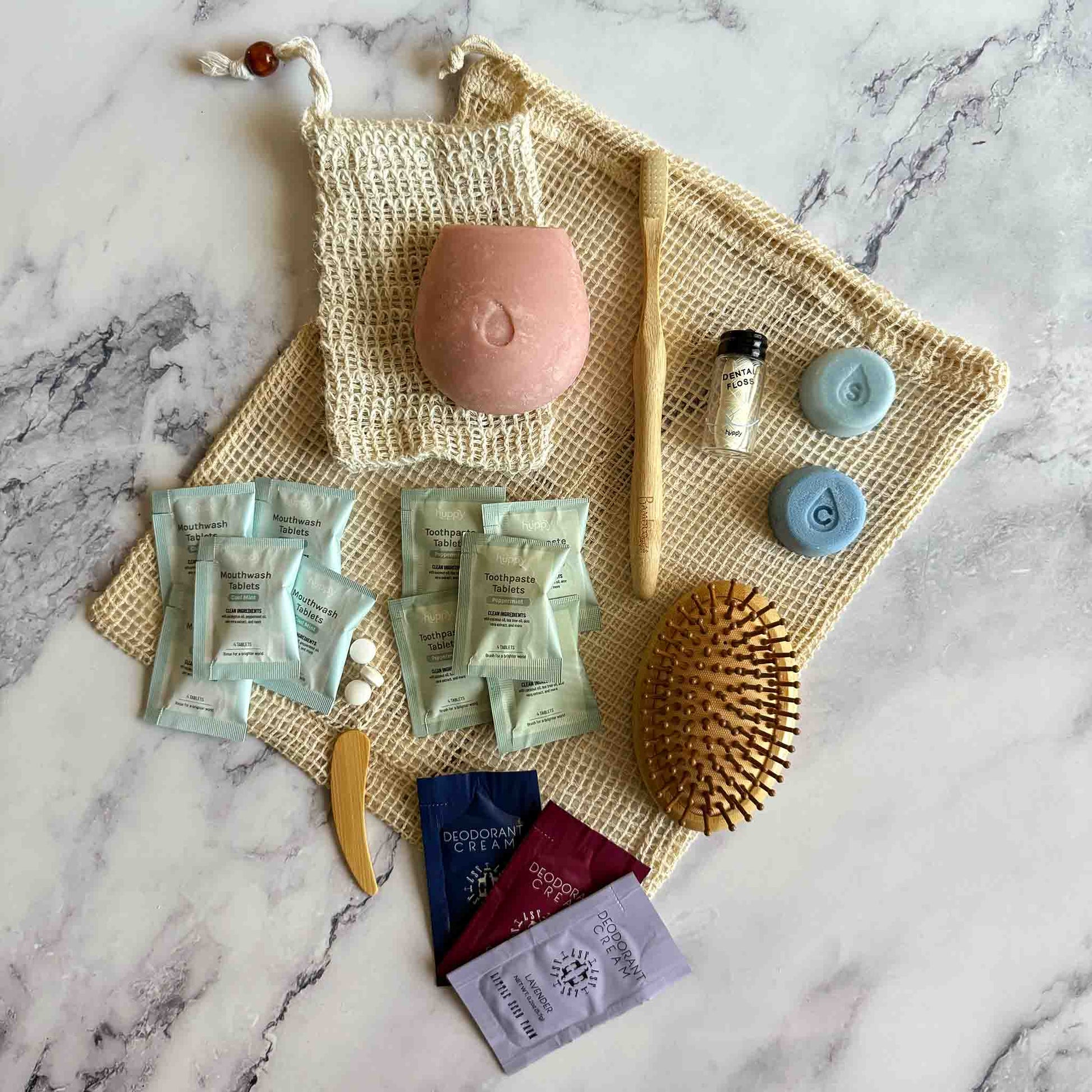 Collection of skincare, oral and hair care products on a marble surface