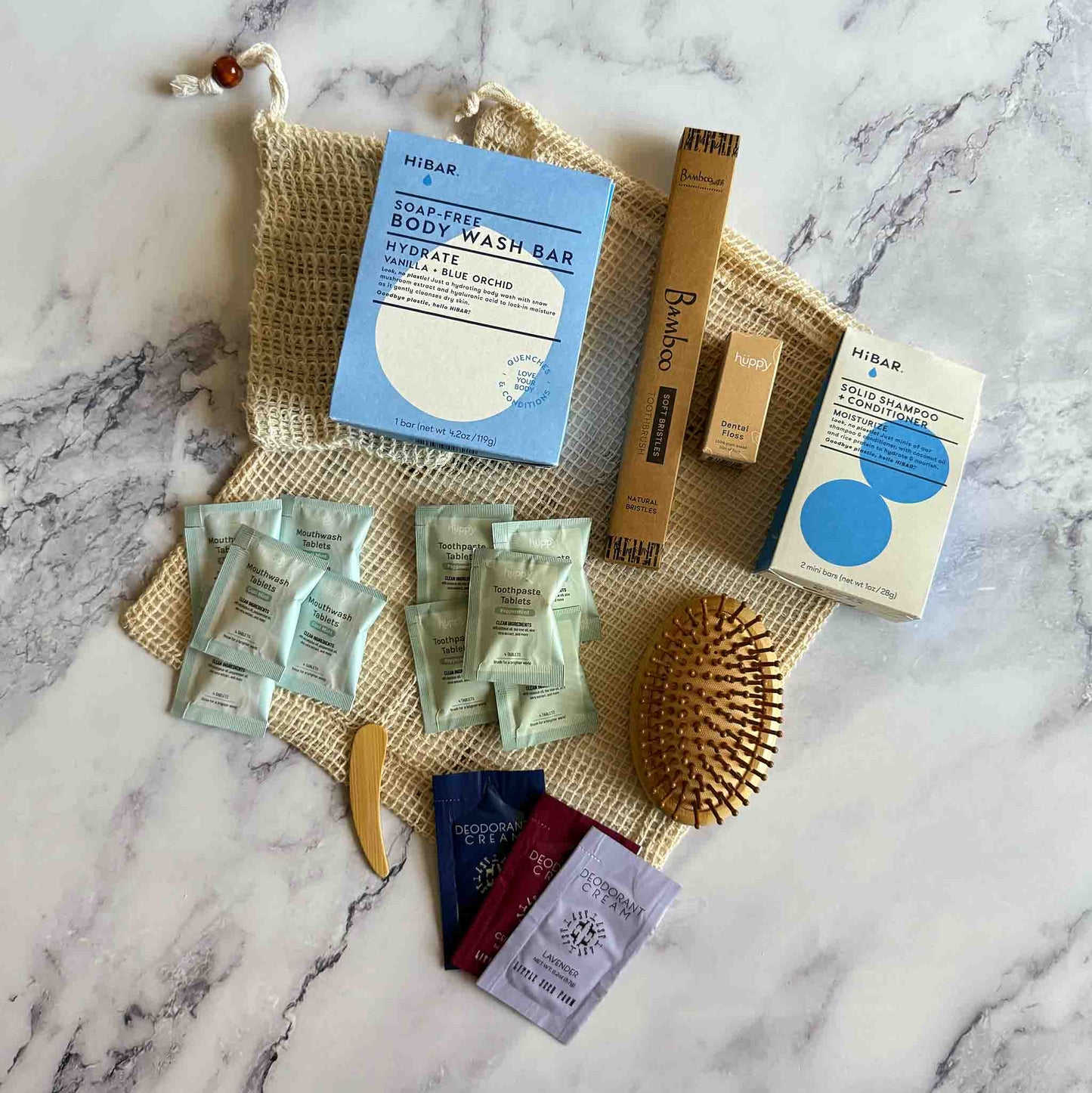 Collection of skin, oral and hair care products on a marble surface